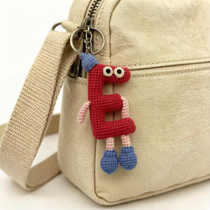Artisan woven uppercase E charm, rucksack ornamental trim, imaginative birthday memento, paired romantic keepsake, Yuletide pack adornment